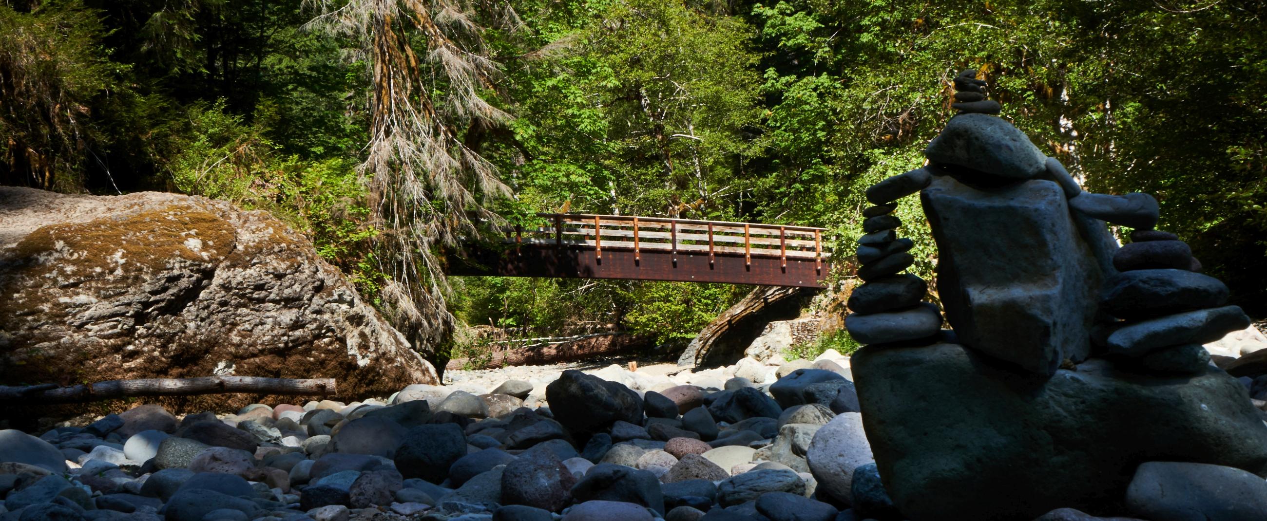 Wooden bridge with rock stack in the foreground